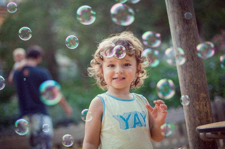Happy toddler playing with bubbles Happy toddler playing with bubbles
