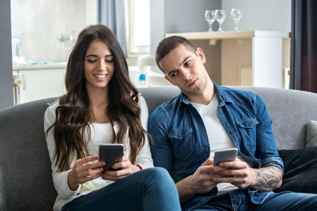 Jealous boyfriend spying his girlfriend’s phone.