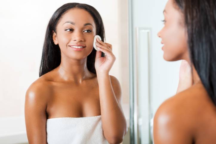 Taking good care of her face.