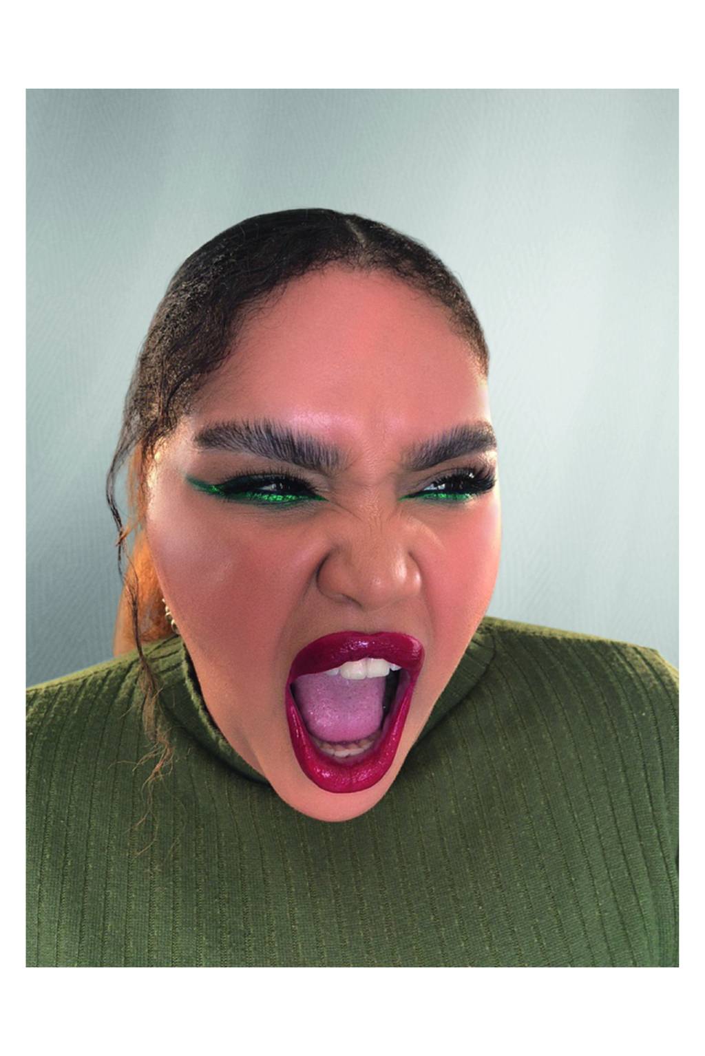 BELEZA Mulher com olho delineado verde e batom vermelho olha para a câmera