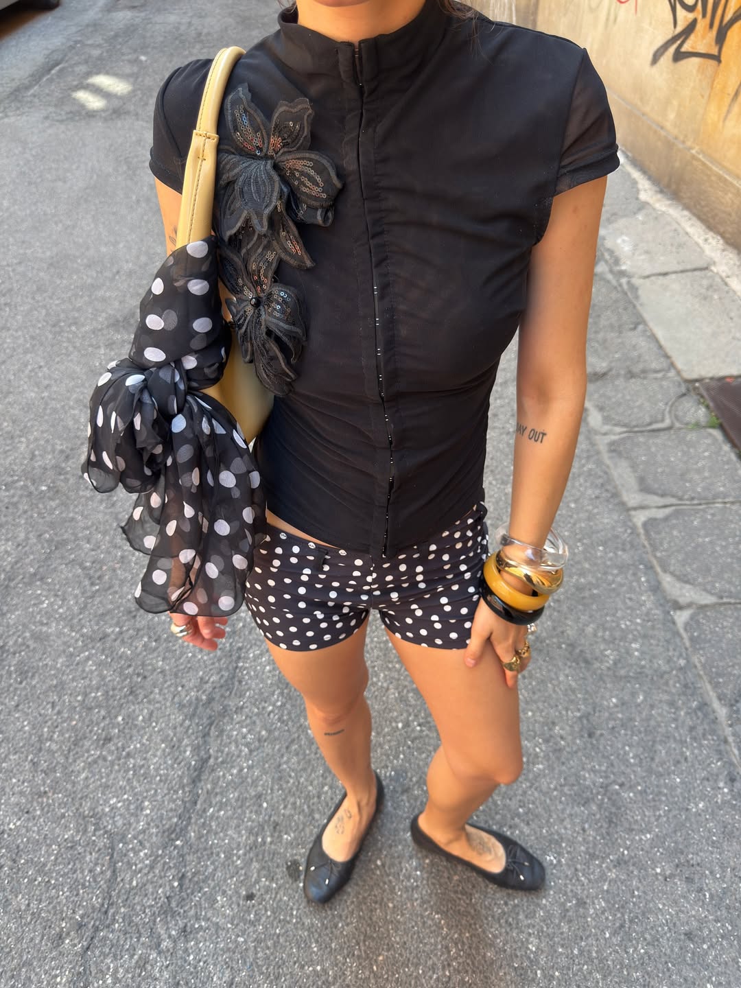 Shorts curtos de po&aacute; com blusa preta estruturada